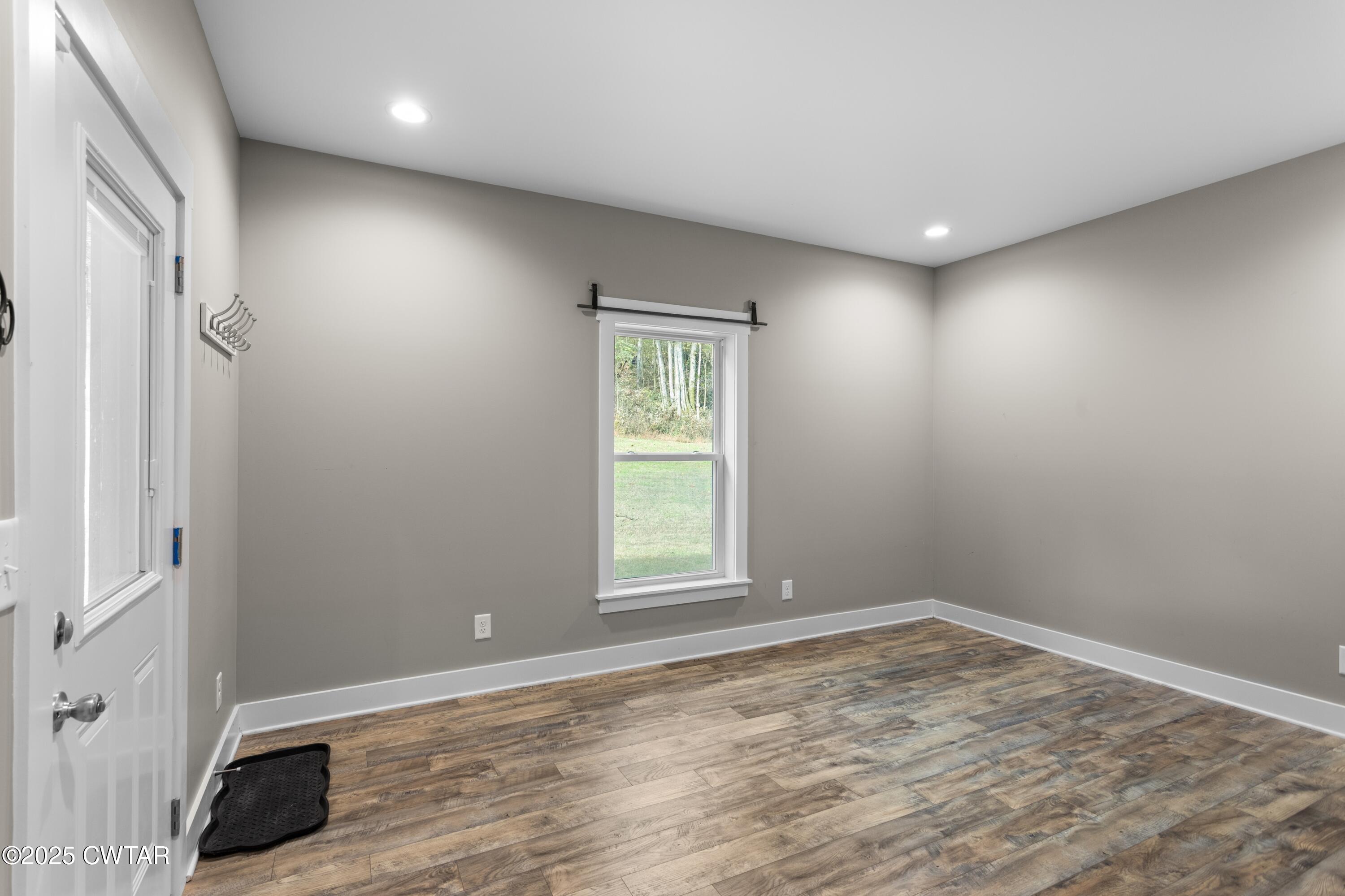 3154 Dodson Gap Road Culleoka, TN 38451 - Photo 30 of 36 an empty room with wooden floor and windows