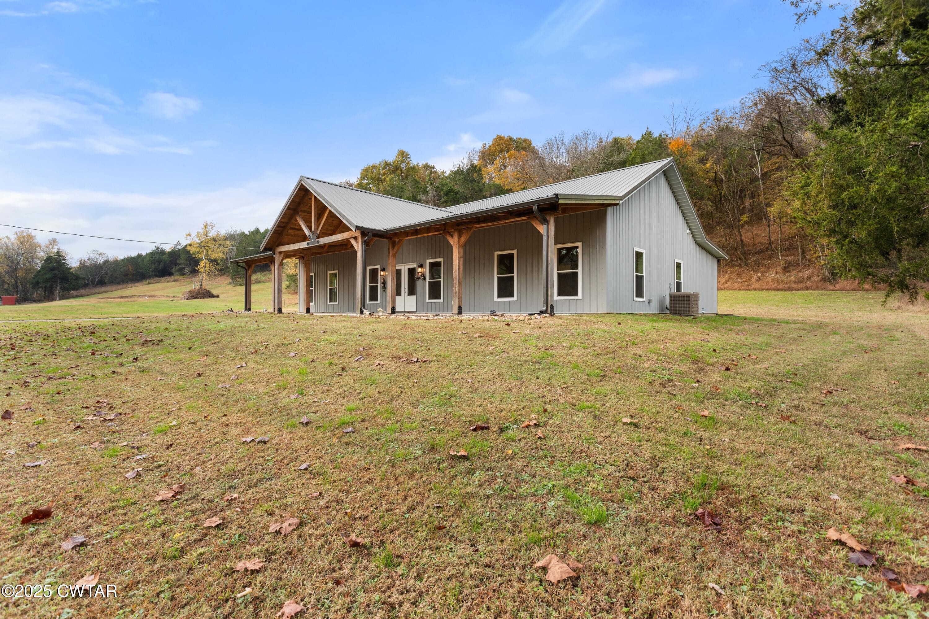 3154 Dodson Gap Road Culleoka, TN 38451 - Photo 3 of 36 a white house with a big yard and large trees
