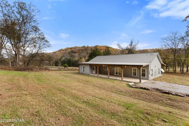 a view of house with outdoor space and garden