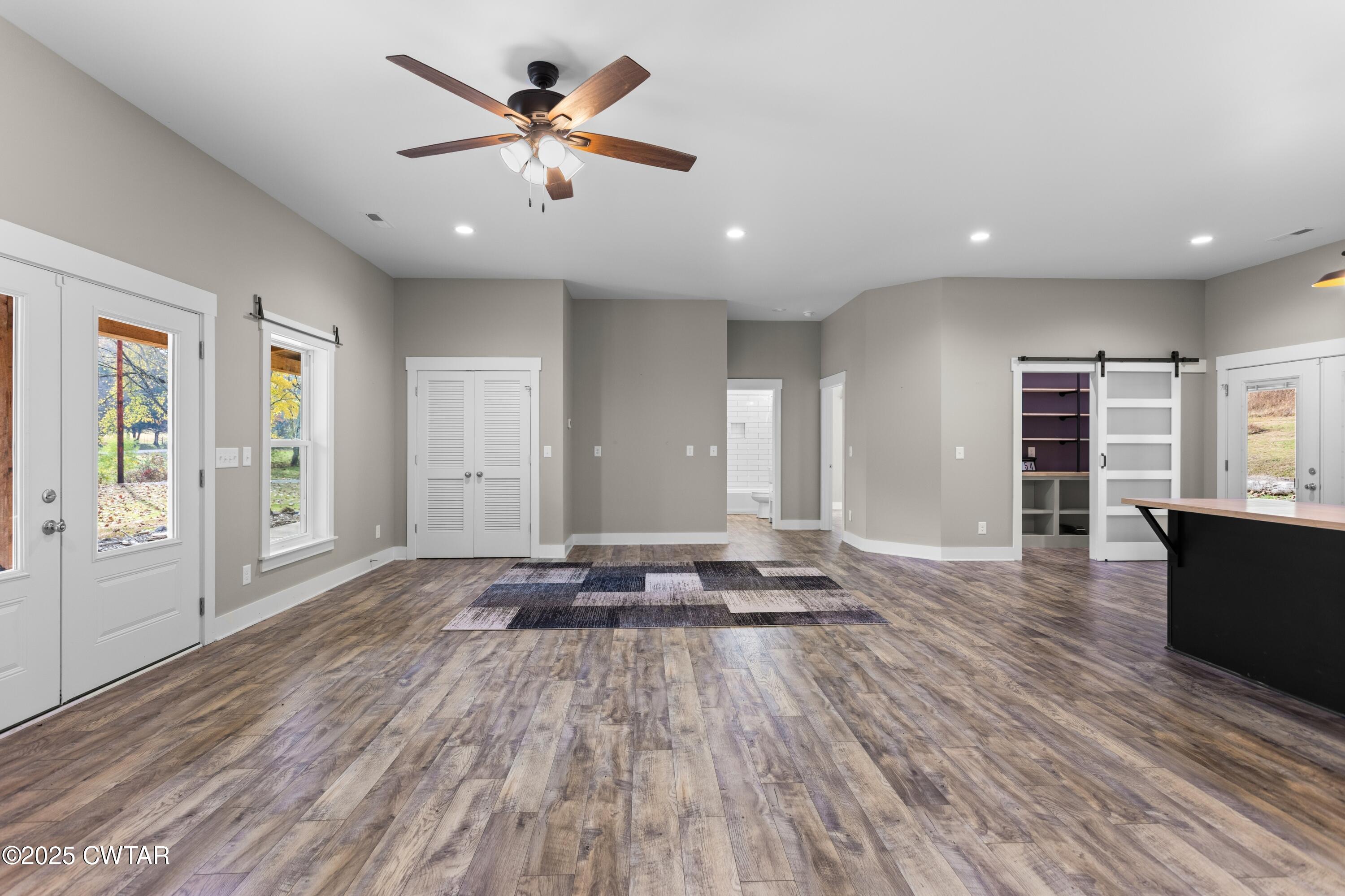 3154 Dodson Gap Road Culleoka, TN 38451 - Photo 8 of 36 a view of a big room with wooden floor and windows