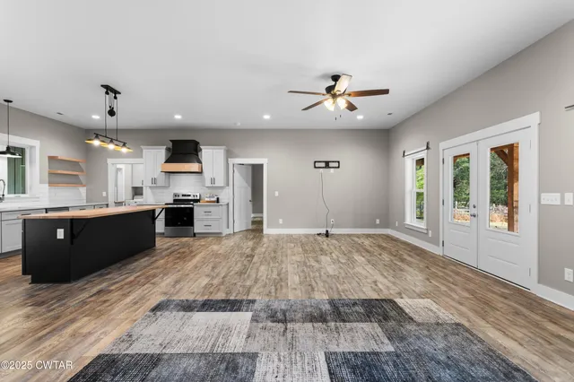 a large kitchen with stainless steel appliances kitchen island granite countertop a stove and a sink