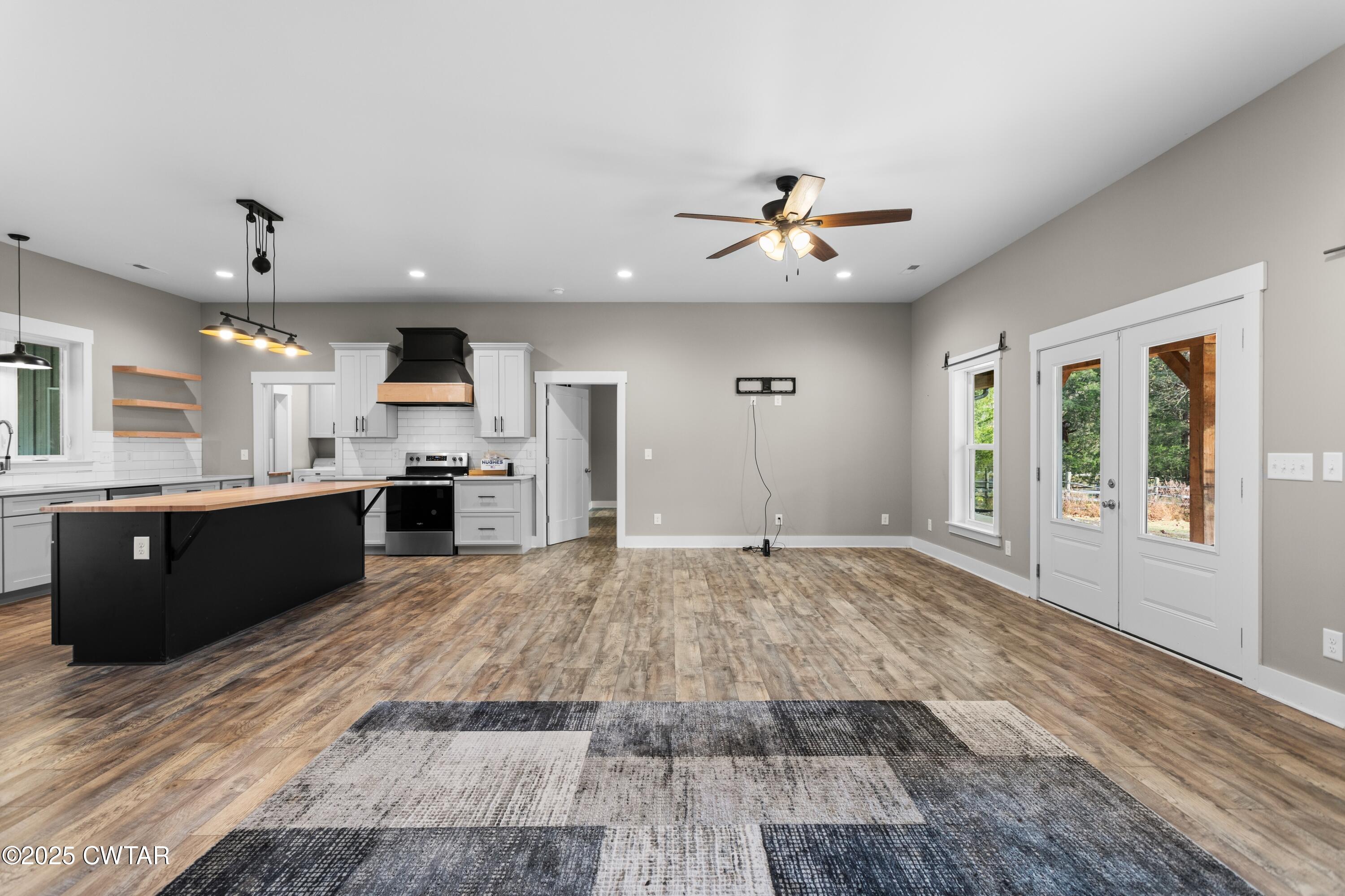3154 Dodson Gap Road Culleoka, TN 38451 - Photo 9 of 36 a large kitchen with stainless steel appliances kitchen island granite countertop a stove and a sink
