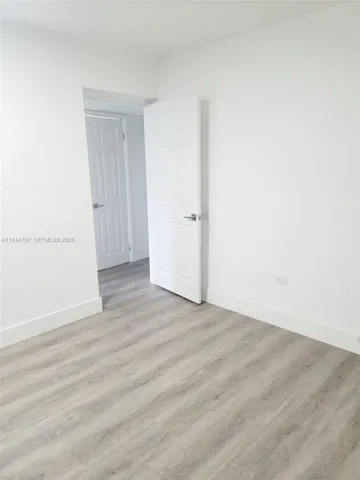 a view of an empty room and wooden floor