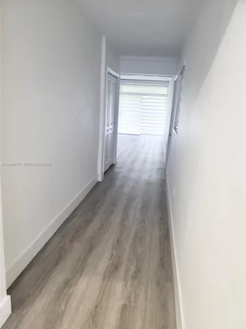a view of wooden floor and windows in a room