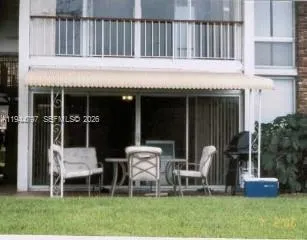 a backyard of a house with table and chairs
