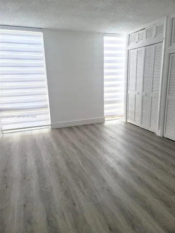 a view of a room with wooden floor and window