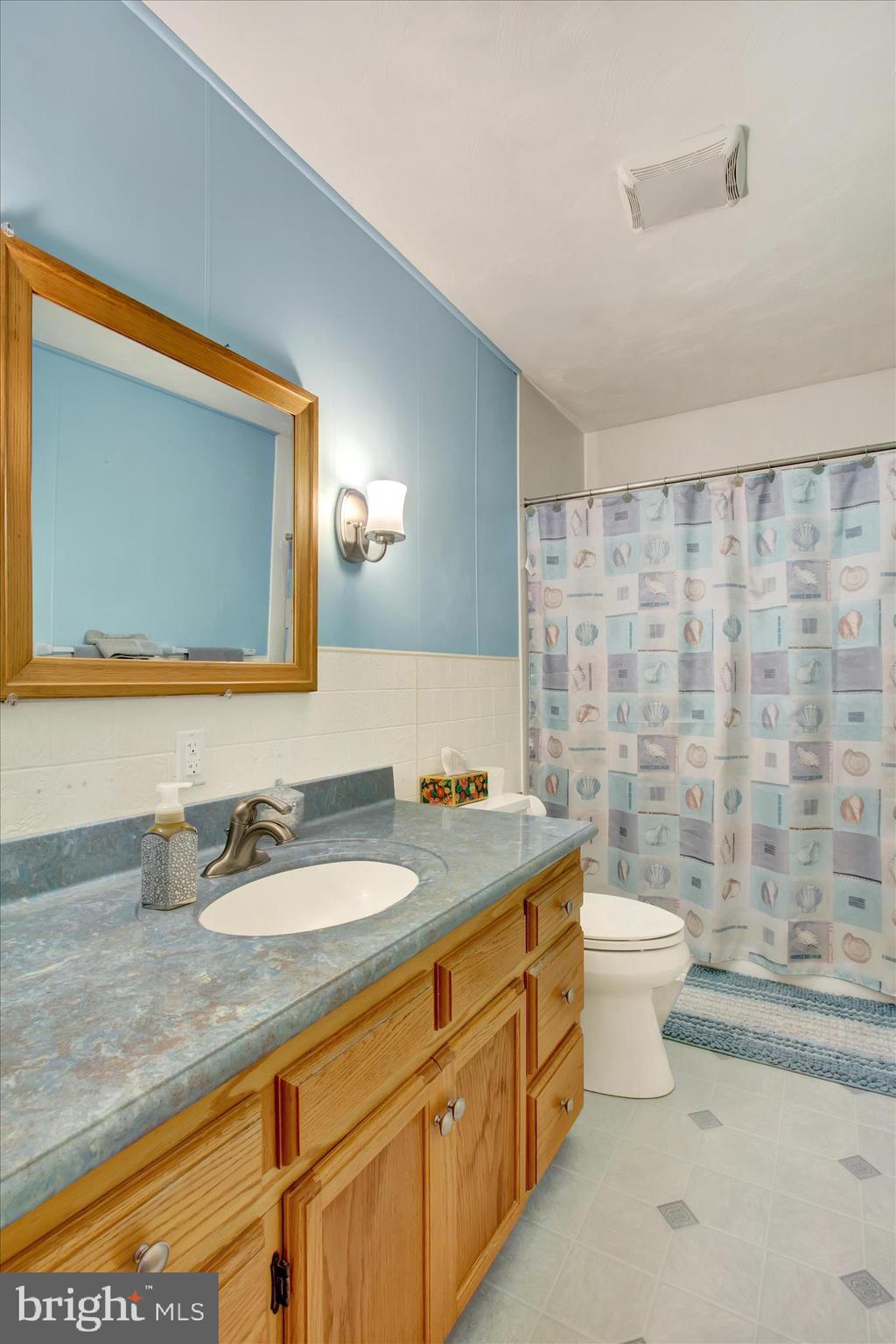 2275 Mummasburg Road Gettysburg, PA 17325 - Photo 12 of 31 a bathroom with a granite countertop sink mirror vanity and toilet