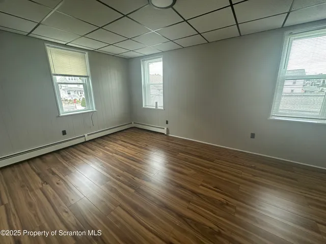 a bathroom with a sink a toilet a mirror and a shower