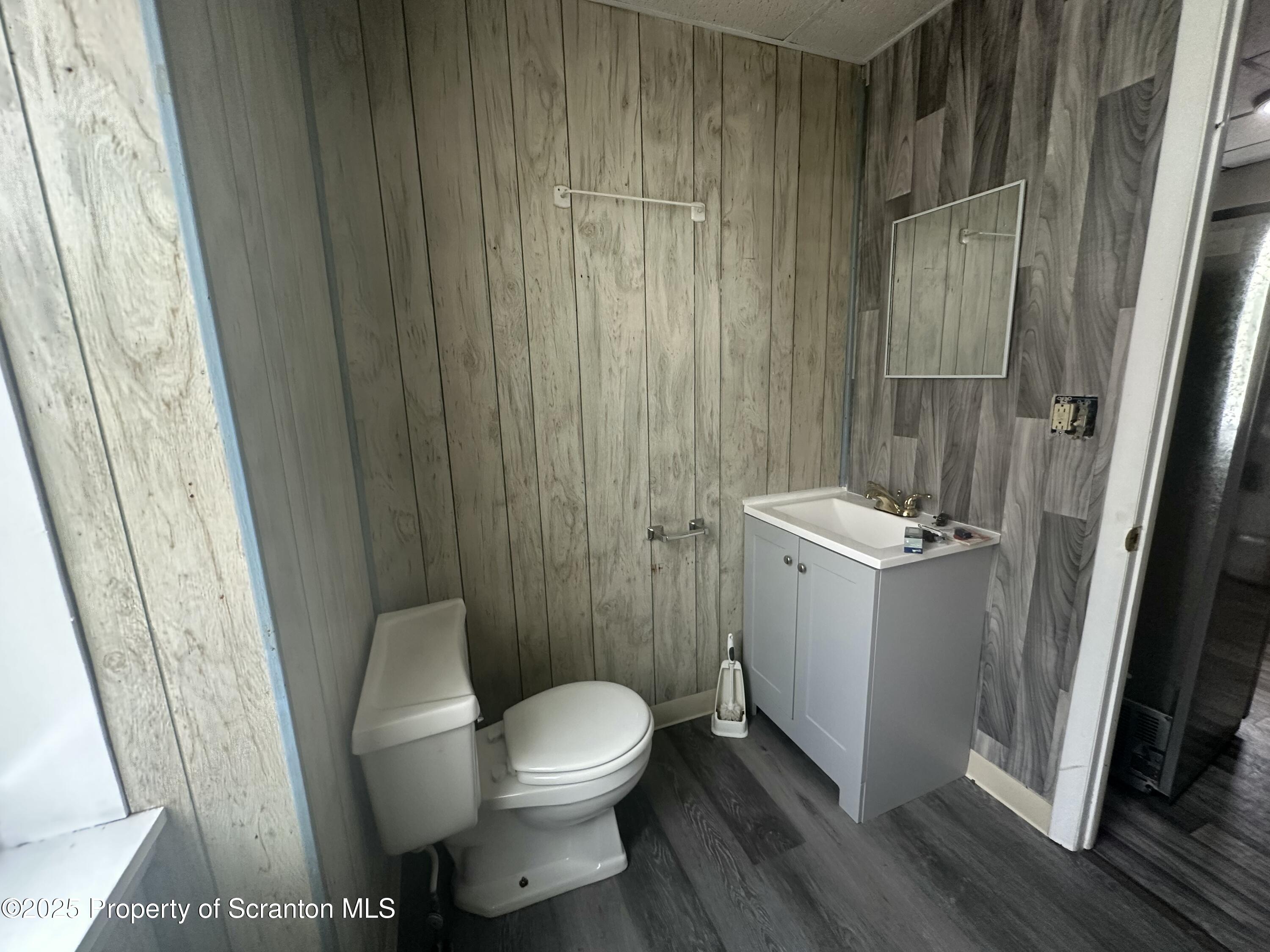 65 Center Street, Unit 2 Pittston, PA 18640 - Photo 12 of 14 a bathroom with a sink a toilet a mirror and a shower