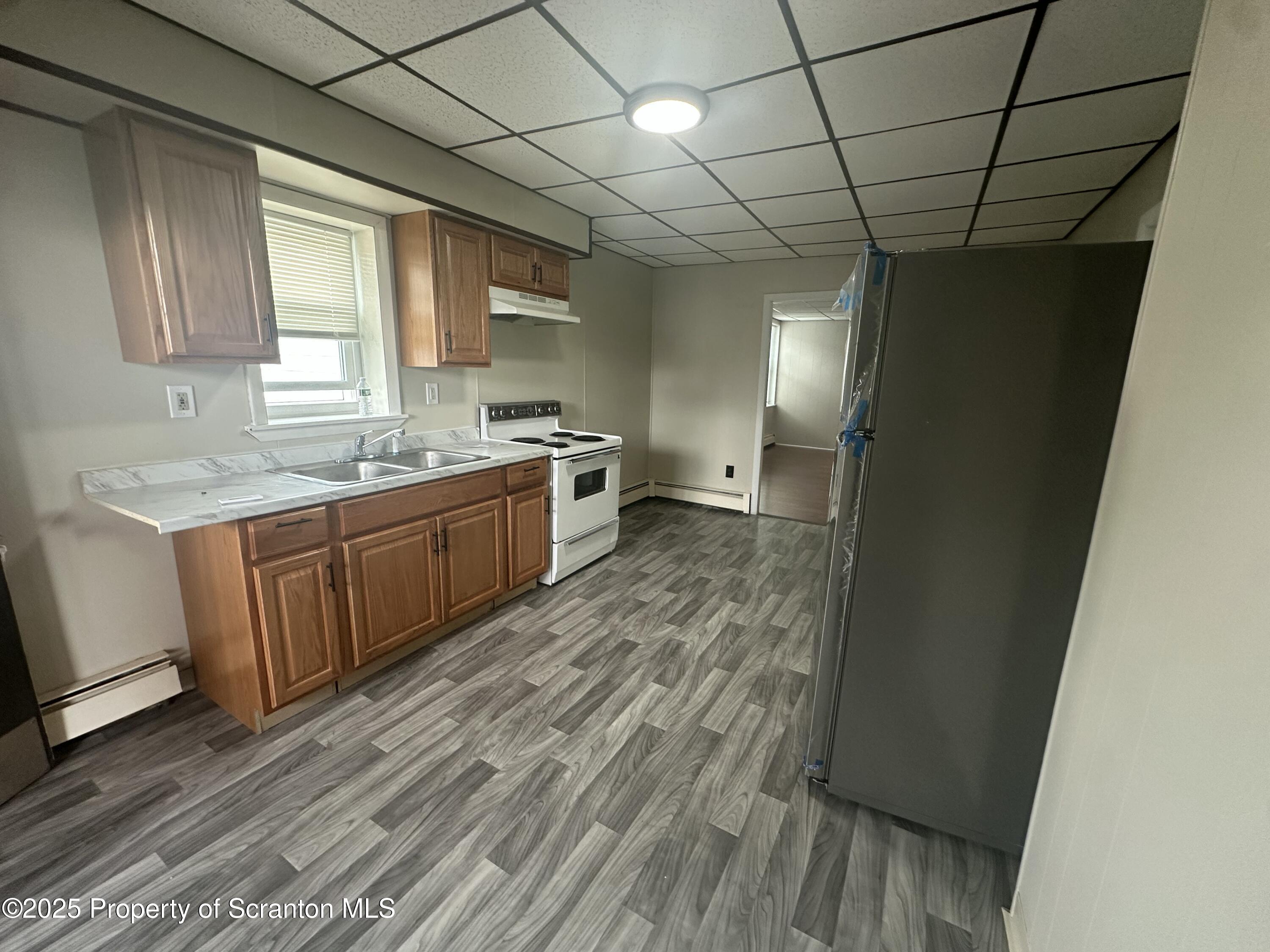 65 Center Street, Unit 2 Pittston, PA 18640 - Photo 5 of 14 a large kitchen with a sink and wooden floor