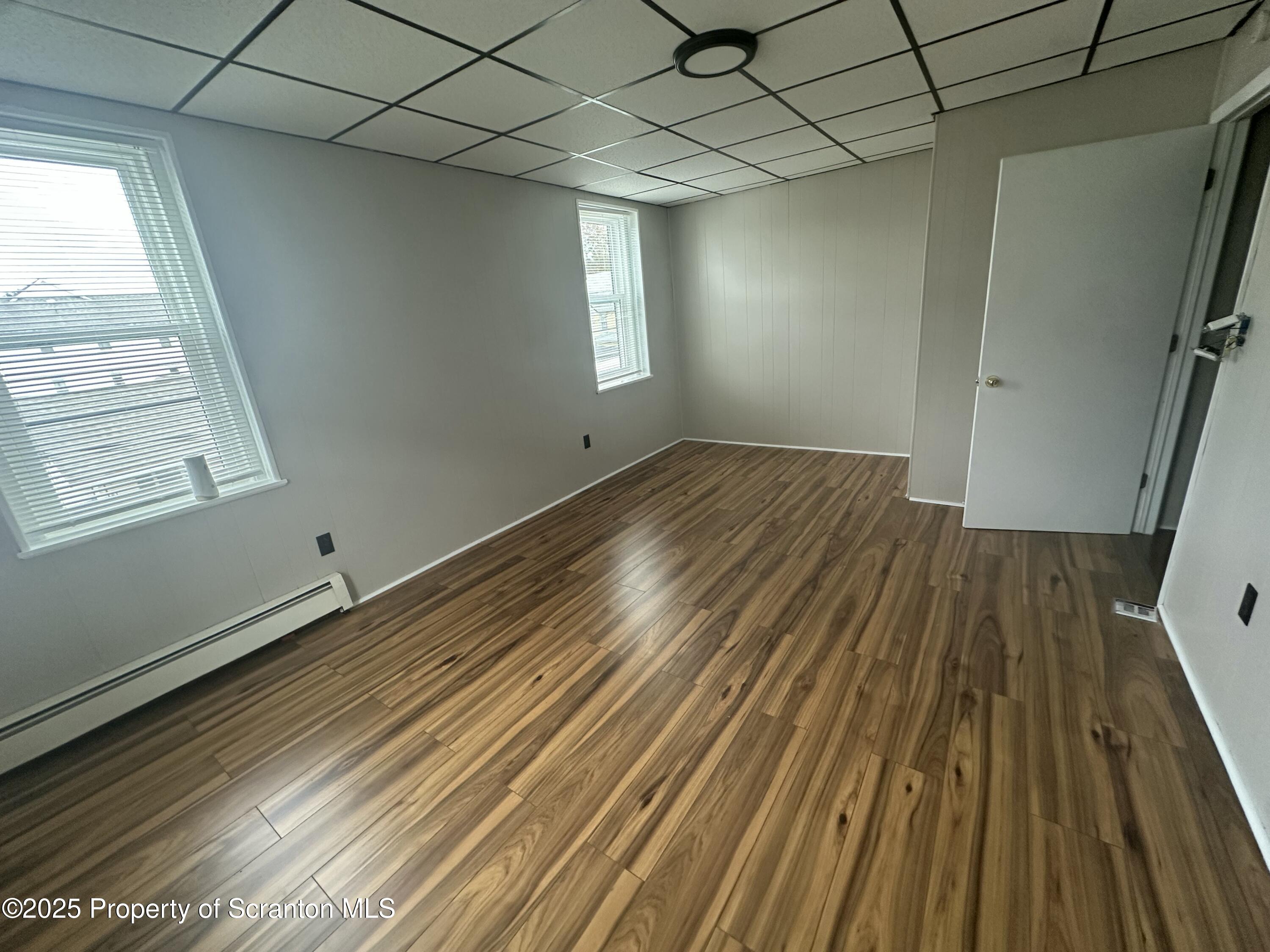 65 Center Street, Unit 2 Pittston, PA 18640 - Photo 10 of 14 a view of empty room with wooden floor and fan