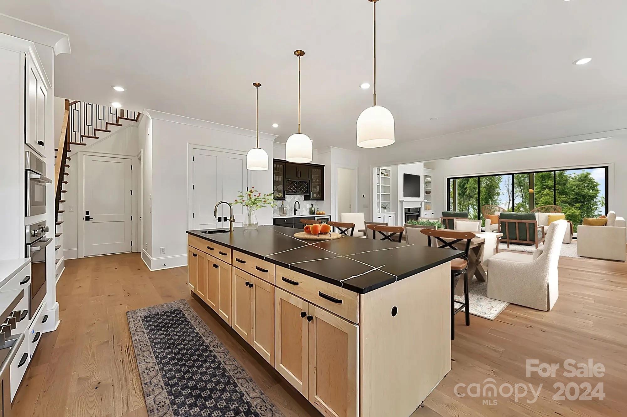 1318 Pomar Circle Marvin, NC 28173 - Photo 4 of 22 a kitchen with a sink stove and living room view