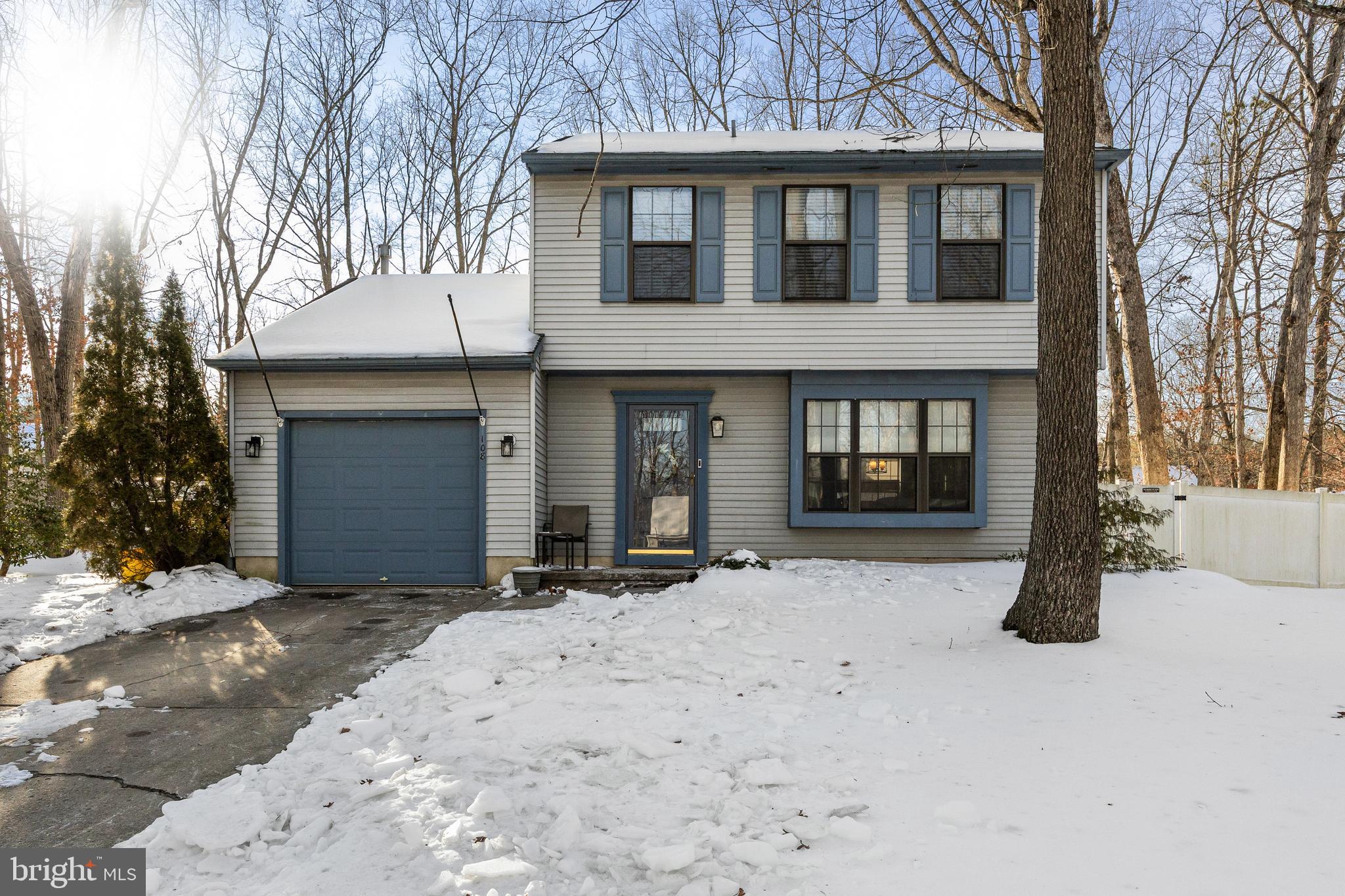 a view of a house with a yard covered in snow