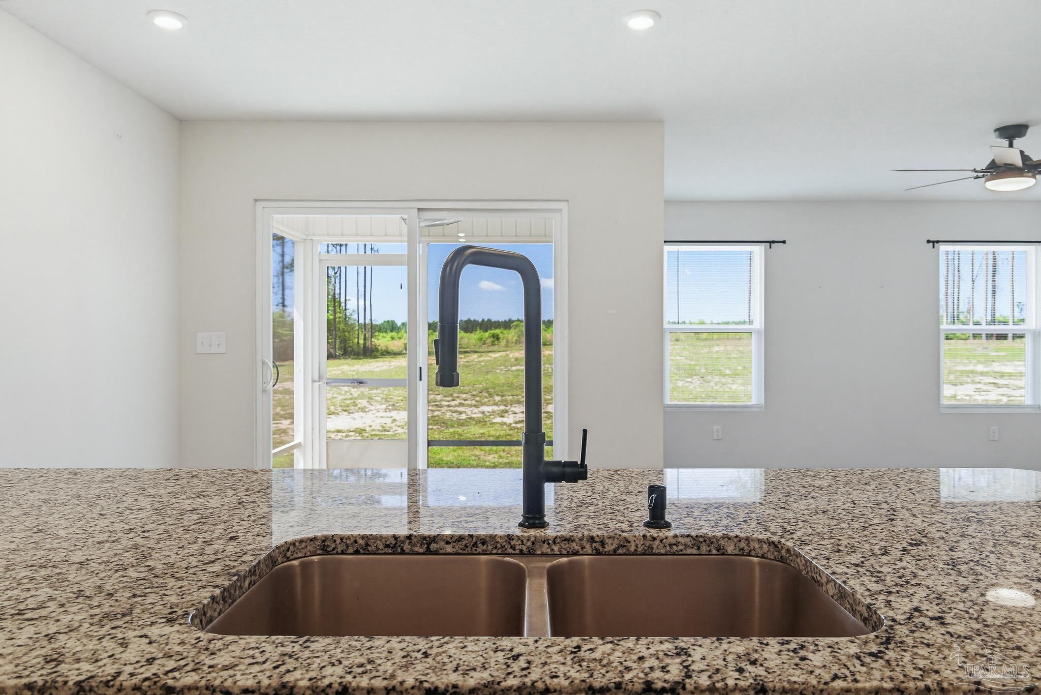 1895 Pineview Church Road Jay, FL 32565 - Photo 27 of 51 a kitchen with a granite countertop sink a stove and a window