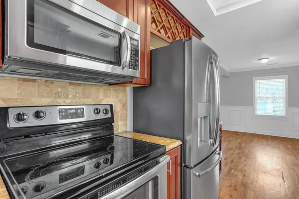 a kitchen with stainless steel appliances granite countertop a sink and a stove