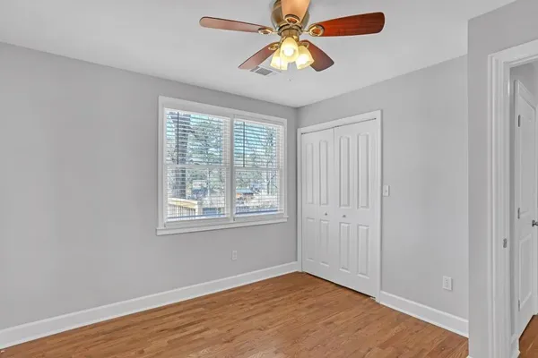 wooden floor in an empty room with a window