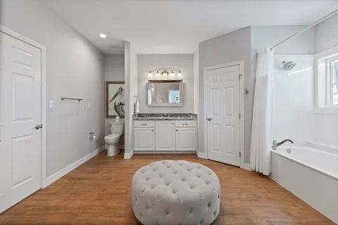 a spacious bathroom with a sink a mirror and a bathtub