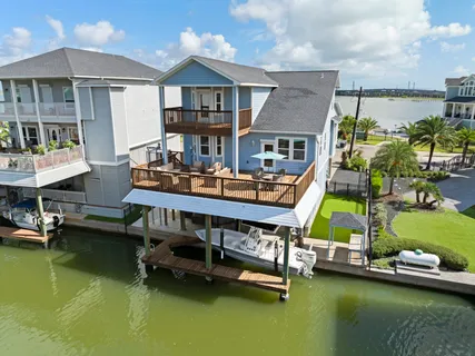 a view of a house with pool and chairs