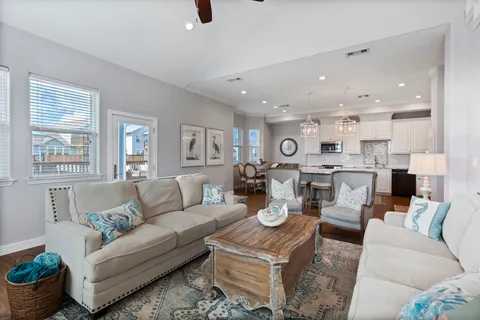 a living room with furniture kitchen and a window