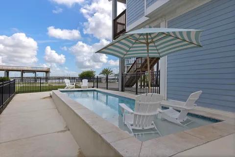 a view of a patio with a table and chairs