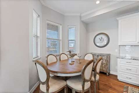 a view of a dining room with furniture and a large window
