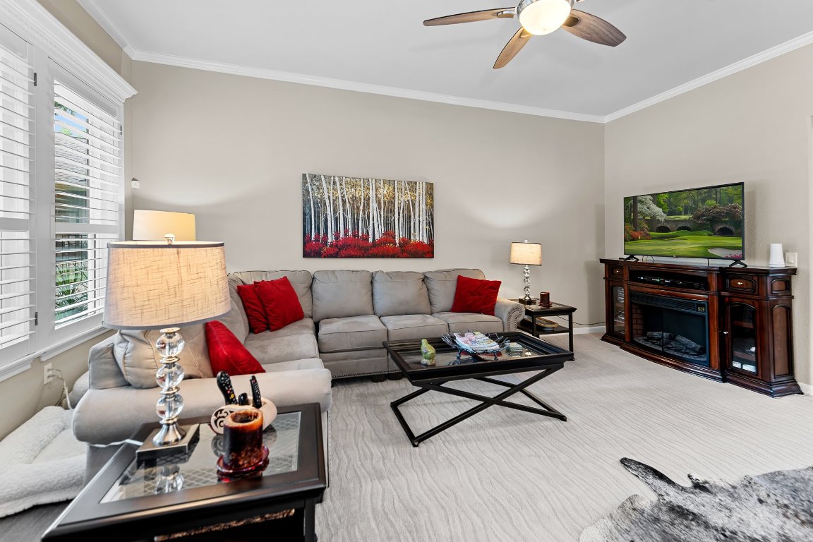 103 Trail Rider Way Georgetown, TX 78633 - Photo 11 of 39 a living room with furniture a rug and a flat screen tv