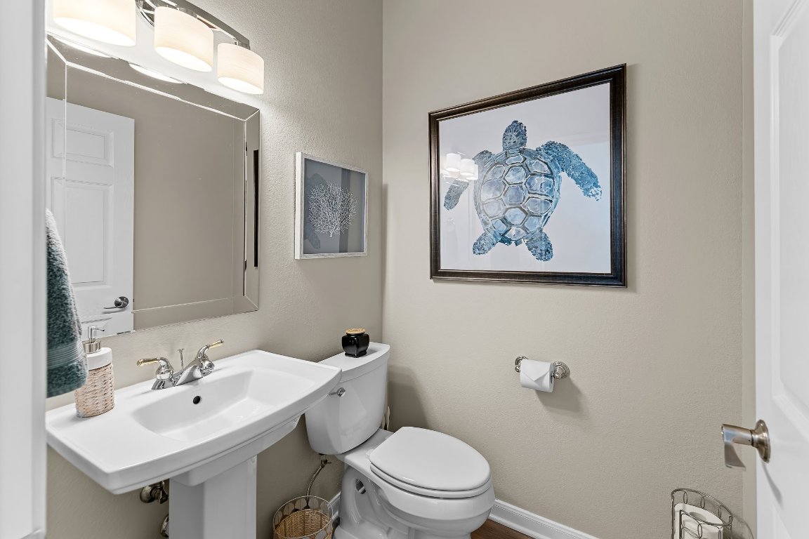 103 Trail Rider Way Georgetown, TX 78633 - Photo 15 of 39 a bathroom with a toilet a sink and mirror