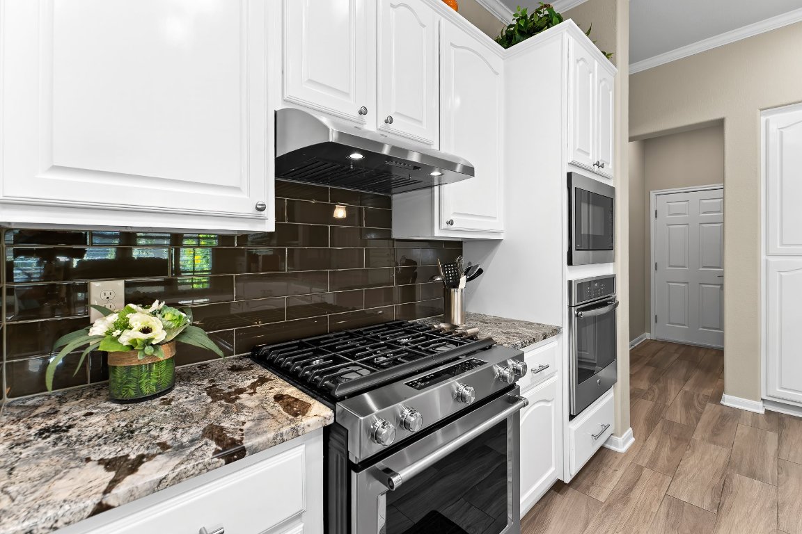 103 Trail Rider Way Georgetown, TX 78633 - Photo 18 of 39 a kitchen with a stove and a refrigerator