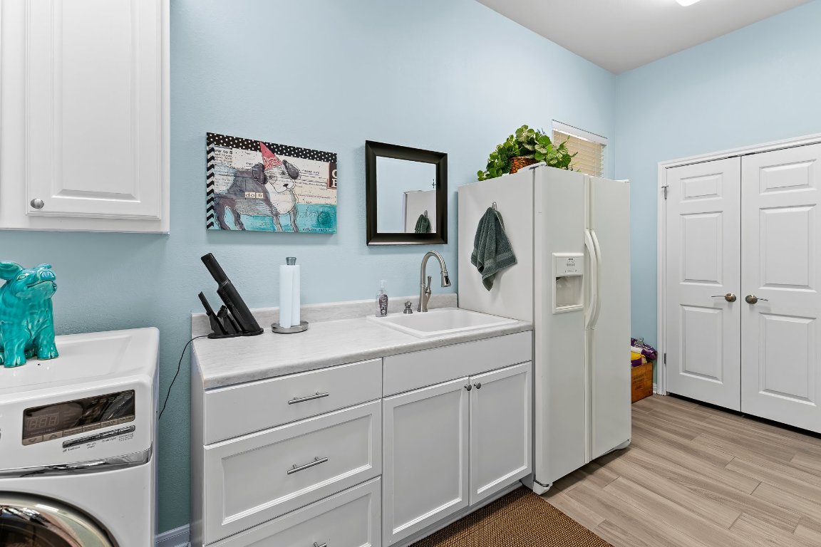103 Trail Rider Way Georgetown, TX 78633 - Photo 25 of 39 a room with a sink and a washer dryer