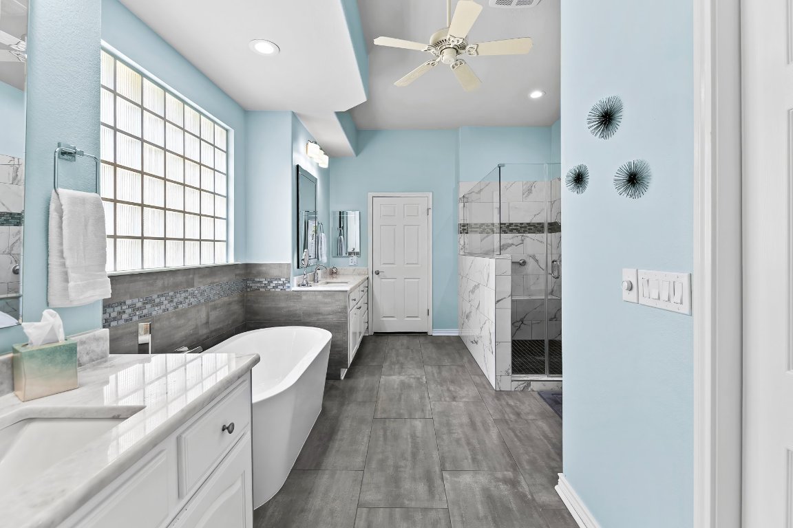 103 Trail Rider Way Georgetown, TX 78633 - Photo 29 of 39 a bathroom with a double vanity sink a mirror and a shower