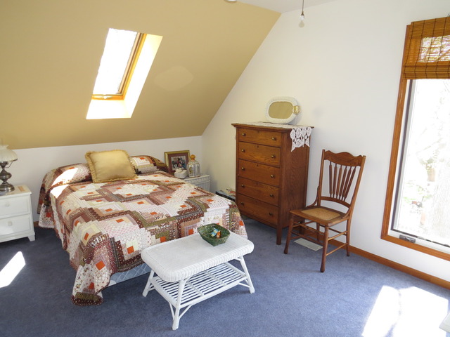 617 Spring Road Ingleside, IL 60041 - Photo 24 of 25 a bedroom with a bed chair and a window
