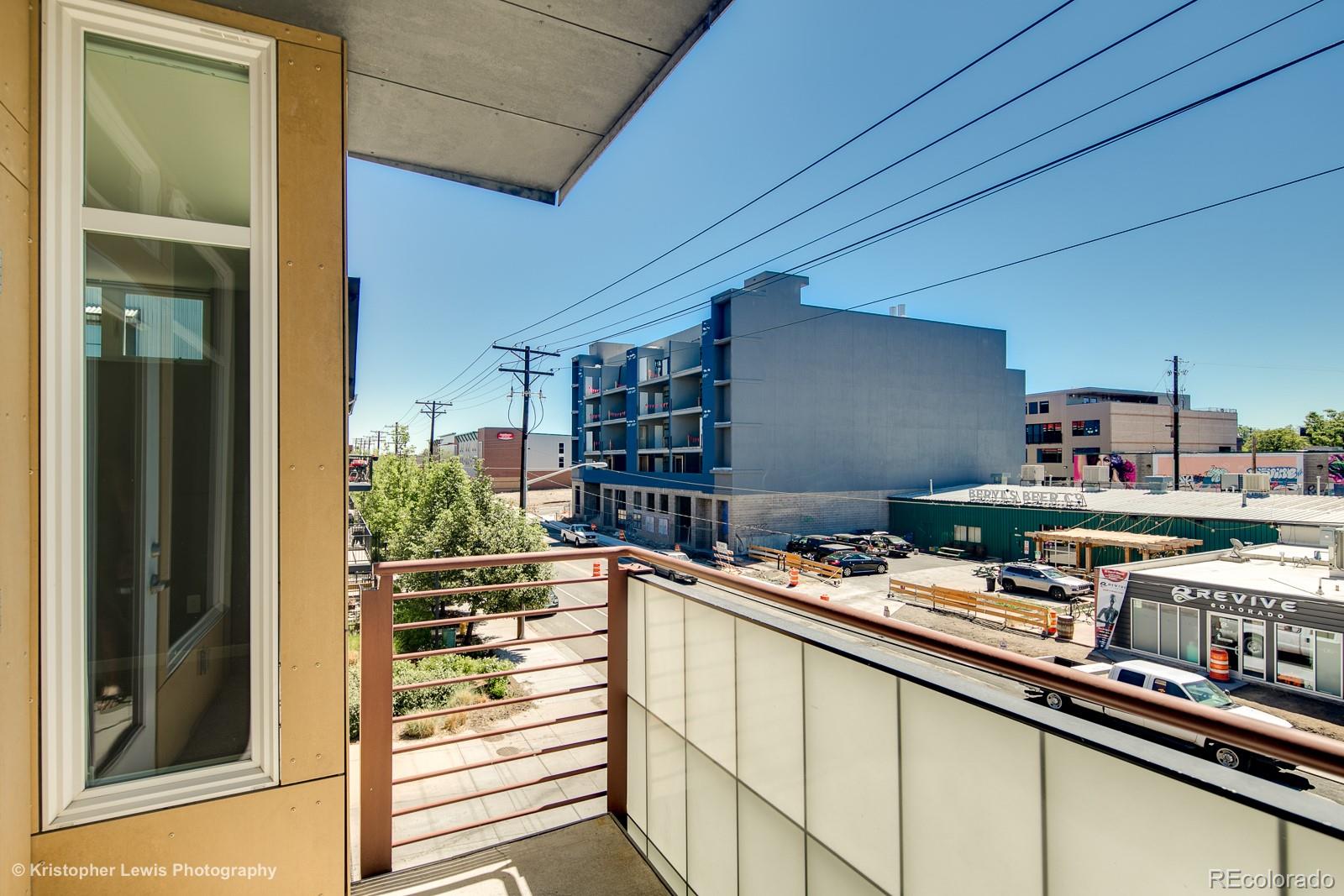 3101 Blake Street, Unit 308 Denver, CO 80205 - Photo 17 of 19 a room with stainless steel appliances kitchen island granite countertop a sink and cabinets