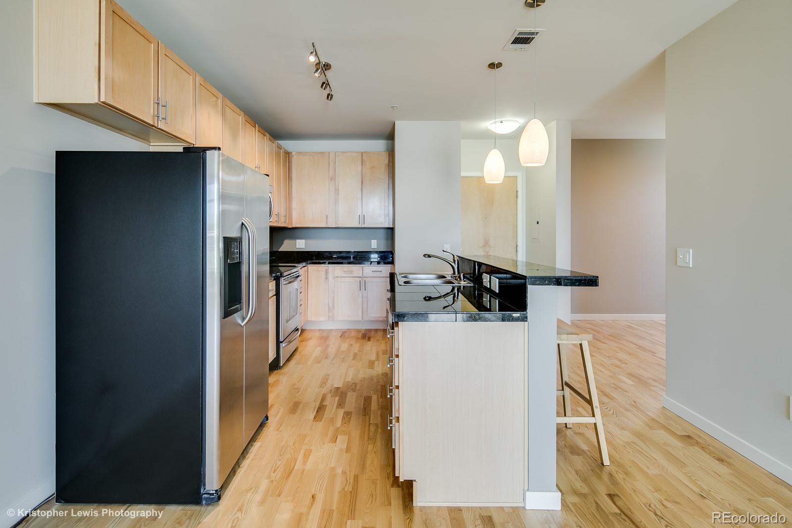 3101 Blake Street, Unit 308 Denver, CO 80205 - Photo 3 of 19 a view of a kitchen with wooden floor