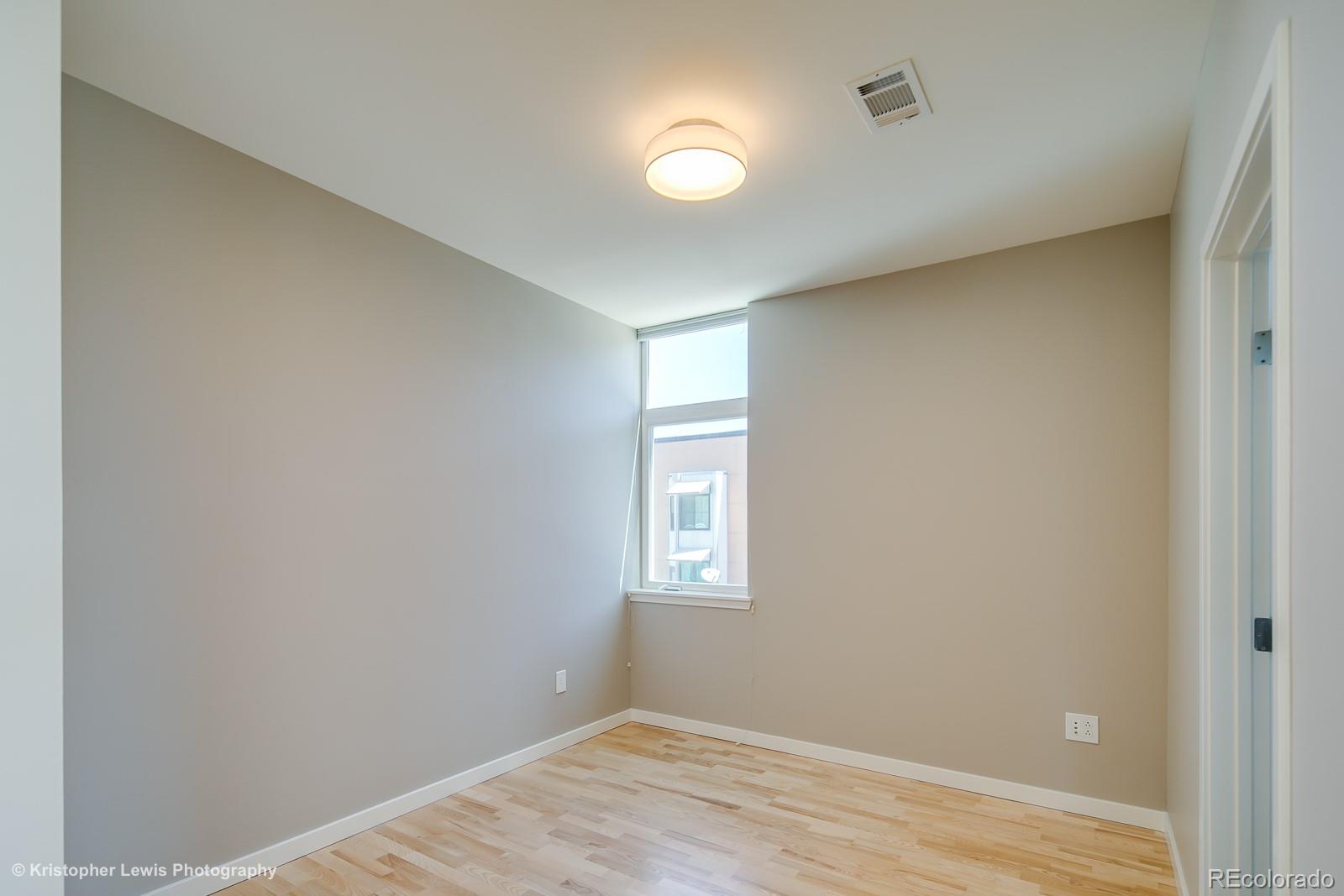 3101 Blake Street, Unit 308 Denver, CO 80205 - Photo 10 of 19 a view of empty room with wooden floor and fan