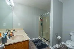 a bathroom with a sink and a mirror with toilet
