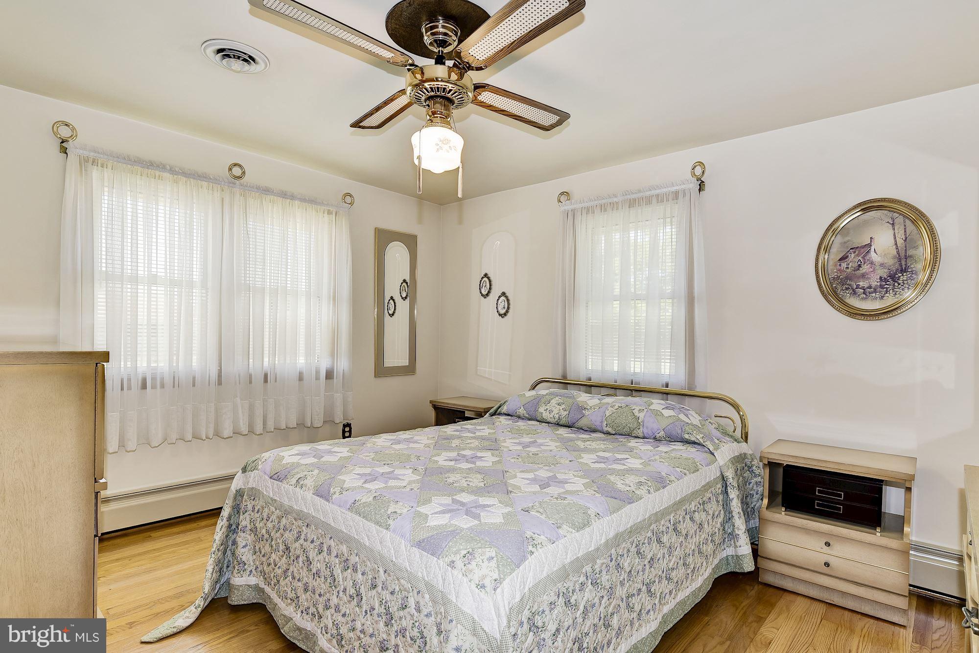 7348 Manchester Road Baltimore, MD 21222 - Photo 14 of 26 a bedroom with a bed and a chandelier