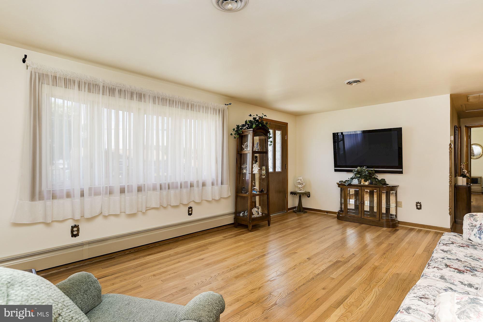 7348 Manchester Road Baltimore, MD 21222 - Photo 3 of 26 a living room with furniture and a flat screen tv