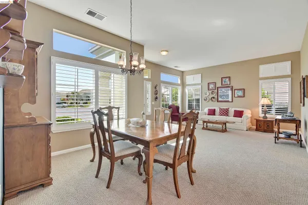 a dining room with furniture and window