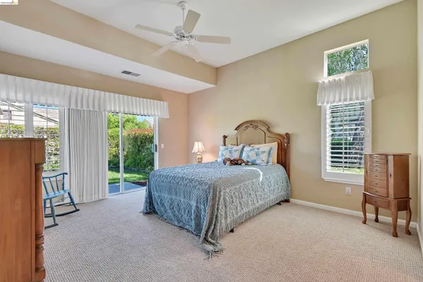 a bedroom with a bed chair and a window