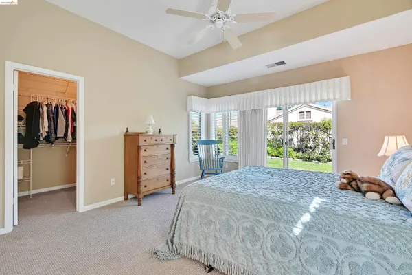 a spacious bedroom with a bed and a walk in closet