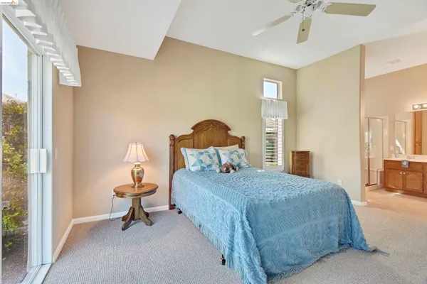 a bedroom with a bed and a lamp
