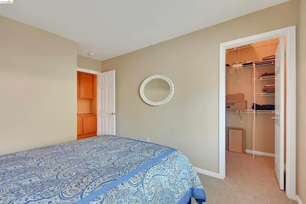 a bedroom with a bed and a mirror