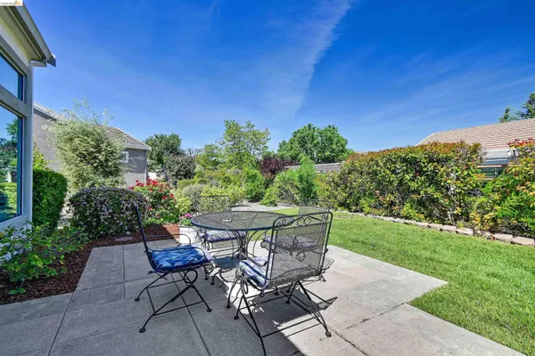 a view of a dining table and chairs in the patio