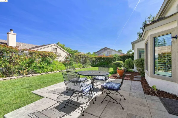 a view of a patio with table and chairs and potted plants