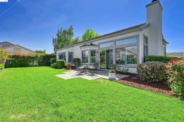 a view of a backyard with sitting area
