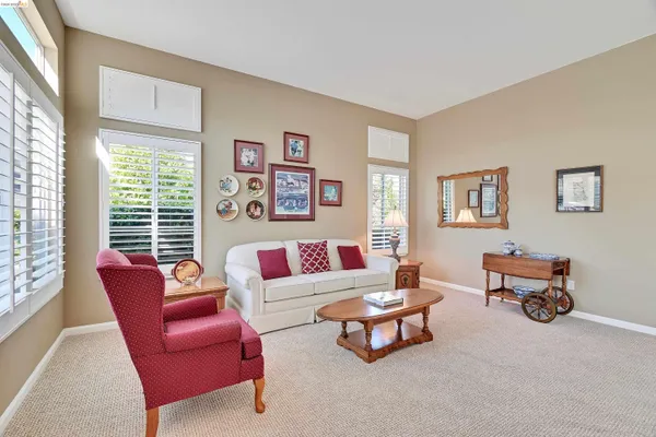 a living room with furniture a rug and a large window