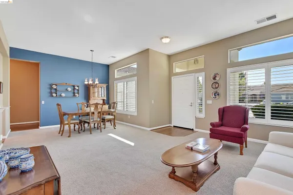 a living room with furniture a rug and a window