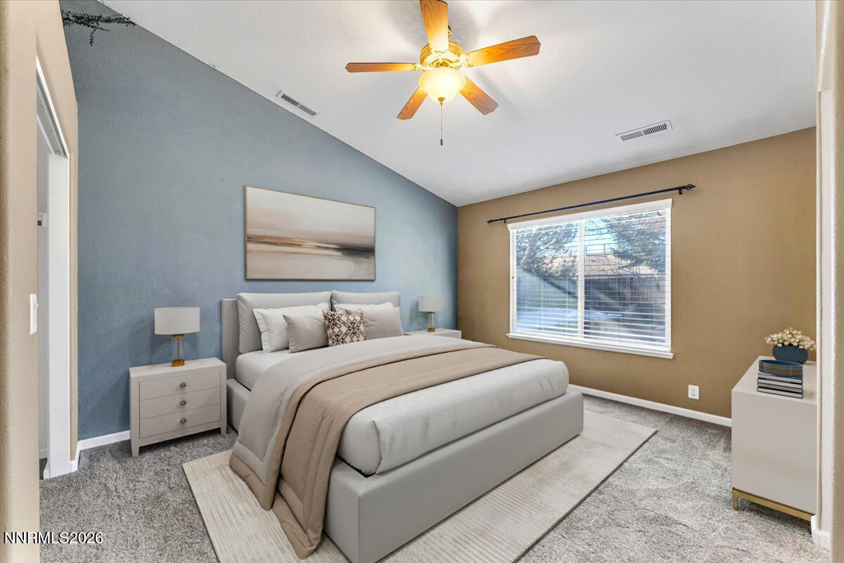 7663 La Ramba Drive Sparks, NV 89436 - Photo 14 of 27 a bedroom with a large bed and a chandelier