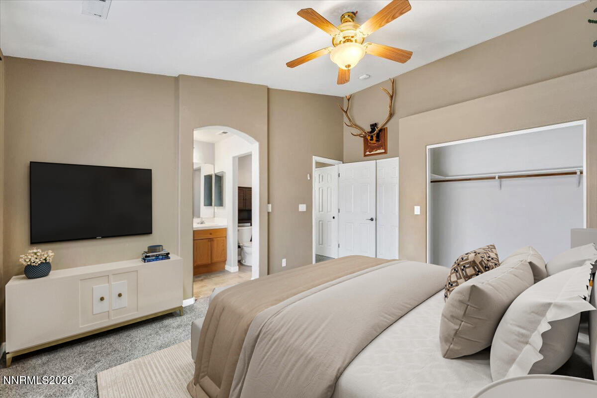 7663 La Ramba Drive Sparks, NV 89436 - Photo 15 of 27 a bedroom with a bed and a flat tv screen on dresser