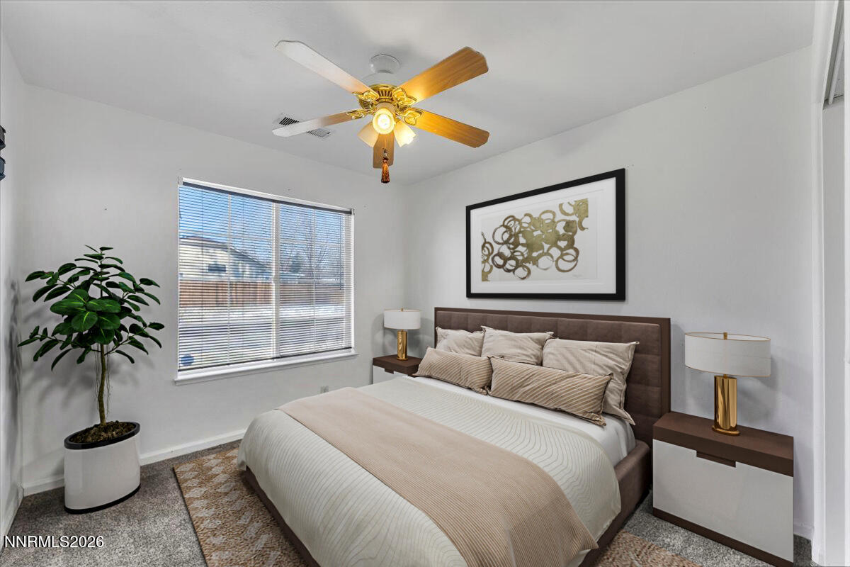 7663 La Ramba Drive Sparks, NV 89436 - Photo 17 of 27 a bedroom with a large bed and a potted plant
